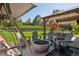 Covered patio with a swing, an outdoor dining area and a backyard playset at 11513 Greenbriar Ln, Parker, CO 80138