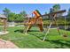 Backyard featuring a colorful play structure with swings and a slide on a well-maintained lawn at 11513 Greenbriar Ln, Parker, CO 80138