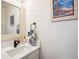 Modern bathroom featuring a stylish vanity, quartz countertop and decorative tropical themed hand towel at 11513 Greenbriar Ln, Parker, CO 80138