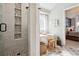 Bathroom featuring a glass shower and a soaking tub next to the bedroom at 11513 Greenbriar Ln, Parker, CO 80138