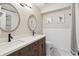 Bathroom featuring dual sinks, framed mirrors, and elegant decor at 11513 Greenbriar Ln, Parker, CO 80138