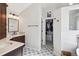Bathroom featuring modern tile flooring and an open closet with storage at 11513 Greenbriar Ln, Parker, CO 80138