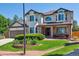 Charming two-story home with manicured lawn, brick accents, and a covered front porch at 11513 Greenbriar Ln, Parker, CO 80138