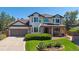 Charming two-story home featuring a manicured lawn and beautiful landscaping at 11513 Greenbriar Ln, Parker, CO 80138