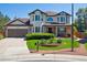 Charming home featuring a manicured lawn with flowering landscape beds and a front porch at 11513 Greenbriar Ln, Parker, CO 80138