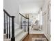 Bright foyer view featuring wood floors, neutral tones, and stairway with black rails at 11513 Greenbriar Ln, Parker, CO 80138