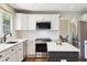 A contemporary kitchen featuring stainless steel appliances, granite countertops, with an island, and view to attached dining area at 11513 Greenbriar Ln, Parker, CO 80138