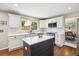 Updated kitchen with sleek countertops, stainless steel appliances, and a cozy island, looking out to a vibrant backyard at 11513 Greenbriar Ln, Parker, CO 80138