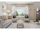Cozy living room with large window, decorative pillows, and comfortable seating at 11513 Greenbriar Ln, Parker, CO 80138