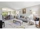 Open-concept living room with elegant decor, neutral colors, and an archway to dining area at 11513 Greenbriar Ln, Parker, CO 80138