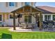 Covered patio area features an outdoor dining set and built-in barbecue at 11513 Greenbriar Ln, Parker, CO 80138
