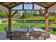 Covered patio area features an outdoor dining set and green views at 11513 Greenbriar Ln, Parker, CO 80138