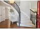 Elegant staircase with dark wood railings and plush carpeting with a light-filled landing at 11513 Greenbriar Ln, Parker, CO 80138