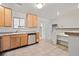 Well-lit kitchen featuring tile floors, wood cabinets, and stainless steel appliances at 10942 W 107Th Pl, Broomfield, CO 80021