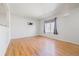 Spacious living room with hardwood floors and a window that brings in natural light at 10942 W 107Th Pl, Broomfield, CO 80021