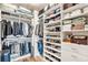 Well-organized walk-in closet with shelving, hanging space, and hardwood flooring at 275 S Harrison St # 210, Denver, CO 80209