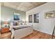 Inviting bedroom with hardwood floors, accent wall, natural light and modern fixtures at 275 S Harrison St # 210, Denver, CO 80209