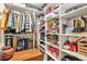 Organized walk-in closet with custom shelving, clothing rods, and ample storage space for clothes and accessories at 275 S Harrison St # 210, Denver, CO 80209