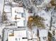 Aerial view showcasing rooftops covered in snow, mature trees, and adjacent neighborhood homes at 1333 Mariposa Ave, Boulder, CO 80302