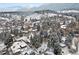 Panoramic aerial view showcases the neighborhood, mountain views, and the property surrounded by mature evergreens in winter at 1333 Mariposa Ave, Boulder, CO 80302