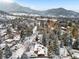 Winter aerial view of a scenic neighborhood nestled in a mountain setting with snow-covered trees and rooftops at 1333 Mariposa Ave, Boulder, CO 80302