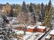 Aerial shot of the house amidst mature trees, with snow-covered roofs, gazebo and surrounding neighborhood at 1333 Mariposa Ave, Boulder, CO 80302