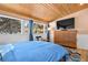 Bright bedroom boasts large windows, wood ceiling, and a flatscreen TV above a dresser at 1333 Mariposa Ave, Boulder, CO 80302