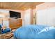 Bedroom with wood ceiling, flatscreen TV, and an adjacent seating area with patterned rug at 1333 Mariposa Ave, Boulder, CO 80302