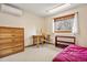 Bedroom with a large window and a dresser near a desk and shelf unit at 1333 Mariposa Ave, Boulder, CO 80302