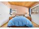 Bedroom with wood ceiling and trim, large window views, and coordinating blue bedding at 1333 Mariposa Ave, Boulder, CO 80302