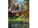 Charming home exterior featuring a lush garden, stone chimney, and a scenic mountain view at 1333 Mariposa Ave, Boulder, CO 80302