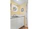 Laundry room with white cabinets, sink, and an octagon window overlooking a snowy landscape at 1333 Mariposa Ave, Boulder, CO 80302