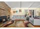 Stylish living room featuring a stone fireplace, comfortable seating, and a view of the outdoor patio at 1333 Mariposa Ave, Boulder, CO 80302