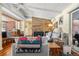 Open-concept living room with a stone fireplace, hardwood floors, exposed ceiling beams and comfortable seating at 1333 Mariposa Ave, Boulder, CO 80302