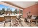 Relaxing covered patio with comfortable seating, firewood, and serene mountain views at 1333 Mariposa Ave, Boulder, CO 80302