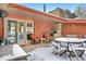 Covered patio featuring a brick fireplace, seating area, and sliding glass doors at 1333 Mariposa Ave, Boulder, CO 80302