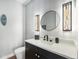 Elegant powder room featuring modern fixtures, a sleek vanity, and decorative lighting at 941 Saint Andrews Ln, Louisville, CO 80027