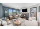Inviting living room with a cozy fireplace, large windows, and stylish furniture at 941 Saint Andrews Ln, Louisville, CO 80027