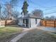 Charming backyard with a new fence, inviting bar window, lush grass, and a walkway at 2824 Cherry St, Denver, CO 80207