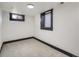 Finished basement room with carpet and two windows at 2824 Cherry St, Denver, CO 80207