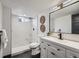 Modern basement bathroom, featuring marble shower and white vanity at 2824 Cherry St, Denver, CO 80207