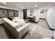 Bright basement living room features modern decor, a comfortable white sofa, and eye-catching artwork at 2824 Cherry St, Denver, CO 80207