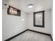 Clean, bright basement room with neutral carpeting and window at 2824 Cherry St, Denver, CO 80207