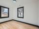 Simple bedroom with hardwood floors and large windows at 2824 Cherry St, Denver, CO 80207