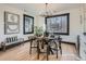 Bright dining room features a wood table and chairs, plus large windows at 2824 Cherry St, Denver, CO 80207