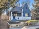 Charming craftsman home with gray exterior, white accents and a well-manicured lawn at 2824 Cherry St, Denver, CO 80207