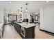 Open concept kitchen with large island, stainless steel appliances and dark cabinets at 2824 Cherry St, Denver, CO 80207