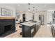 Modern kitchen with large island, stainless steel appliances and white cabinets at 2824 Cherry St, Denver, CO 80207