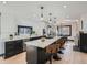 Modern kitchen with island, stainless steel appliances, and white cabinets at 2824 Cherry St, Denver, CO 80207