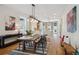 Bright dining room featuring a long wooden table with black chairs and hardwood floors at 1661 Adams St, Denver, CO 80206